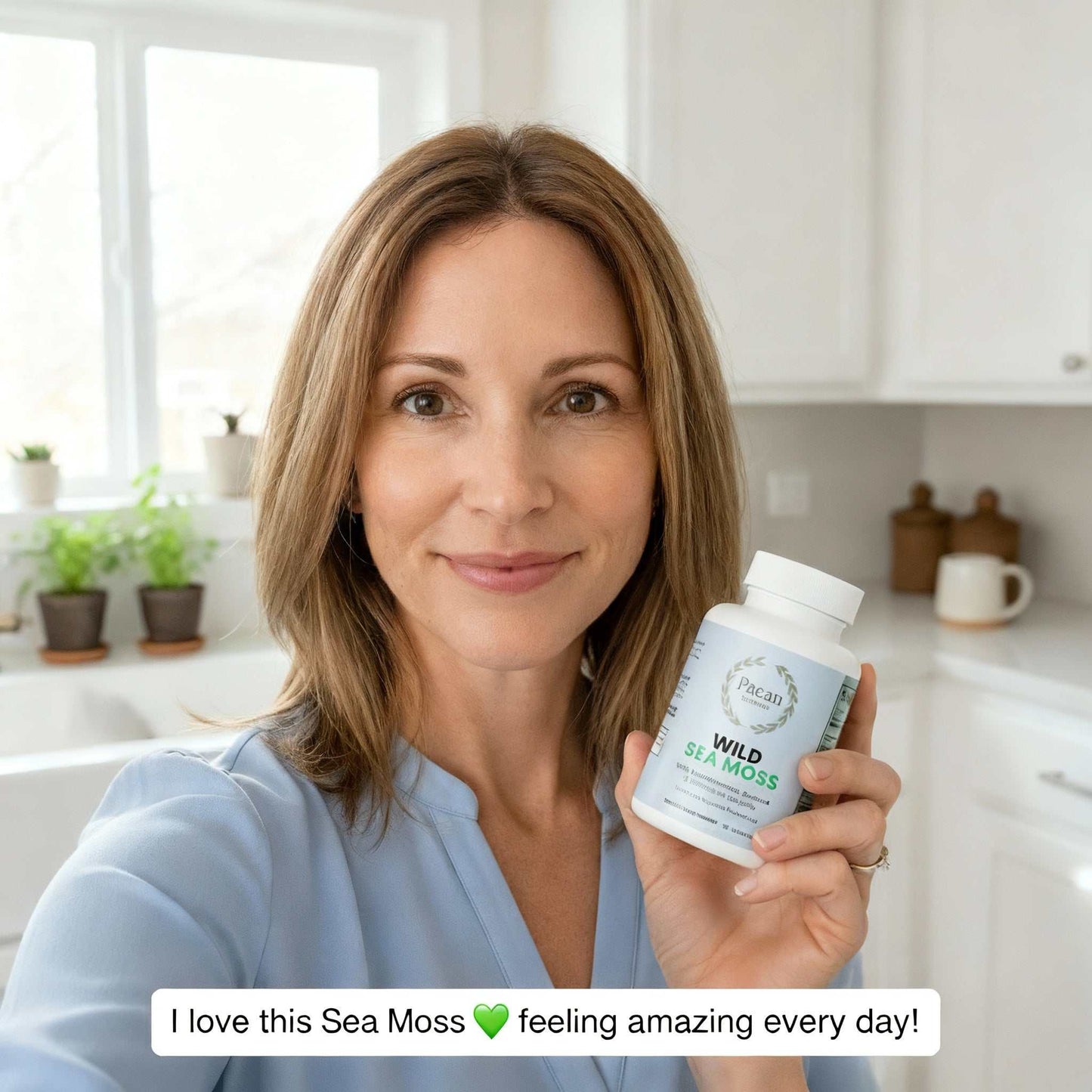 woman holding Ocean Complete Wild Sea Moss supplement bottle in kitchen promoting Wild Sea Moss superfood blend