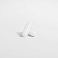 Two white Ocean Pure Magnesium Glycinate supplement capsules on a white background